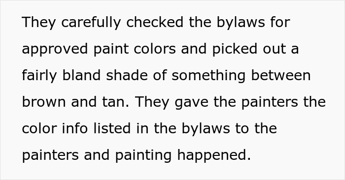 Couple checking HOA bylaws for approved paint colors before painters proceed with chosen neutral shade.