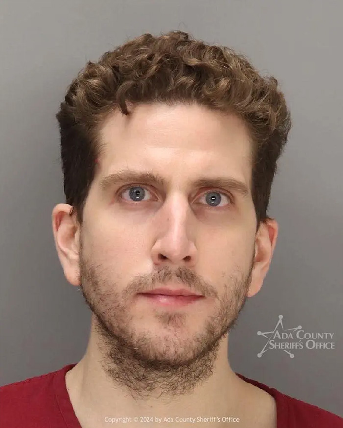 Mugshot of Bryan Kohberger with curly hair and beard, related to autopsy reports on his victims' final moments. Mugshot of Bryan Kohberger with curly hair and beard, related to autopsy reports on his victims' final moments.