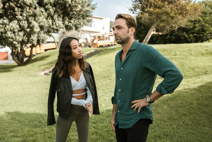 Couple having a serious conversation outdoors, illustrating common dating gestures and relationship communication.