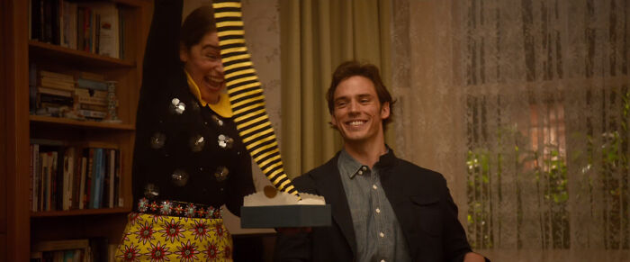 A couple sharing a joyful moment indoors, highlighting dating gestures and questioning the acceptance of the bare minimum.