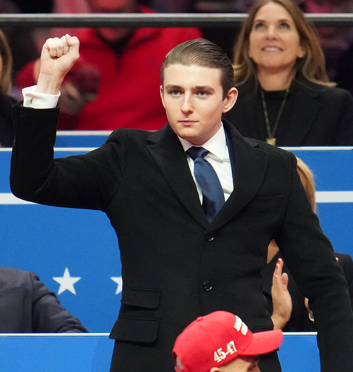 Barron Trump raising fist at event, related to late-night emergency call challenged by judge.