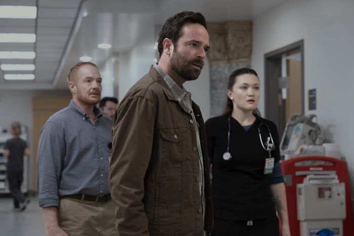 Three cast members from The Pitt Season 2 episode 3 in a hospital hallway, featuring key guest stars from the series.