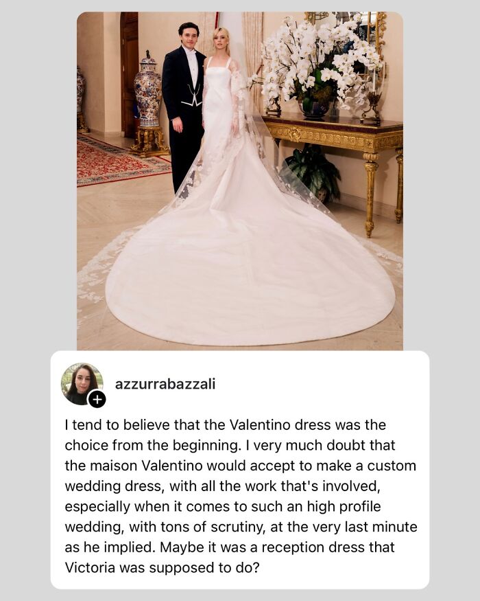 Victoria Beckham in a wedding dress with a long train standing beside the groom in an elegant interior setting.