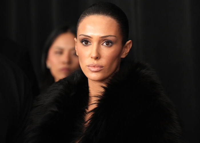 Bianca Censori wearing a black fur coat with sleek hair, showcasing her unexpected talent breaking the internet.