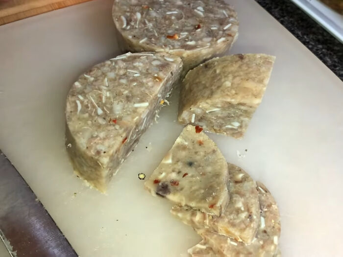 Sliced local delicacy with visible chunks and spices, illustrating unusual and disgusting food from different countries.