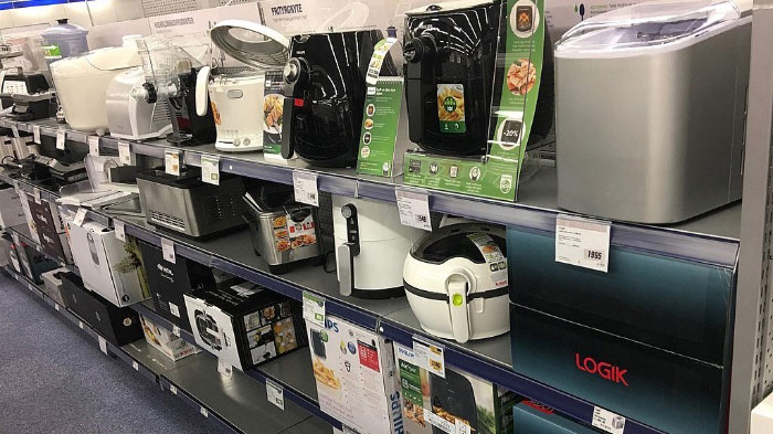Kitchen appliances including air fryers and bread makers displayed on store shelves illustrating common boomer opinions on household gadgets.