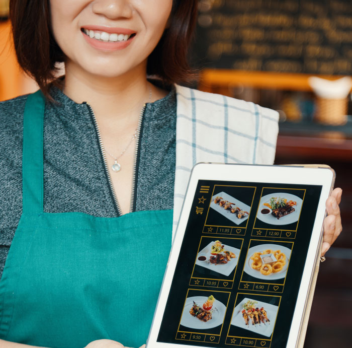 Person in green apron holding tablet displaying digital menu, related to people sharing their most boomer opinions.