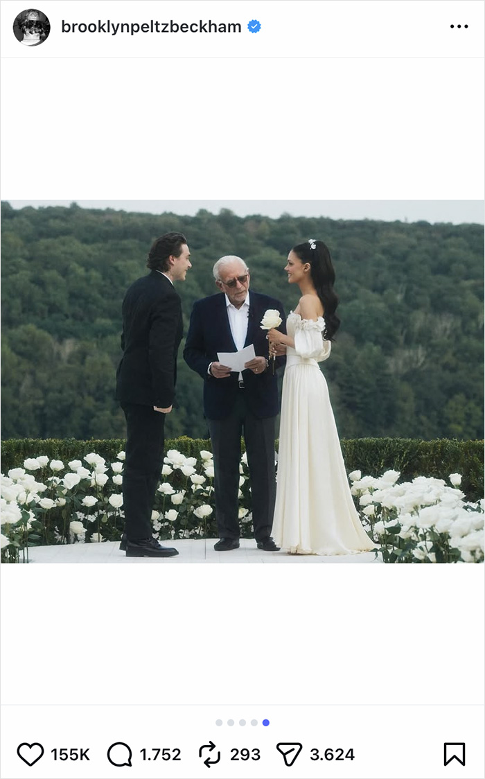 Brooklyn Beckham and bride in wedding attire with officiant among white flowers at outdoor ceremony, prenup ties to Peltz family.