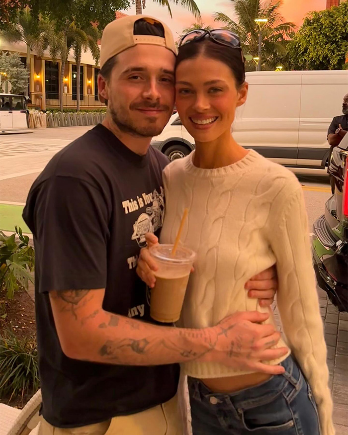 Brooklyn Beckham hugging a woman outdoors, smiling, amid family drama and legal letter involving parents David and Victoria.