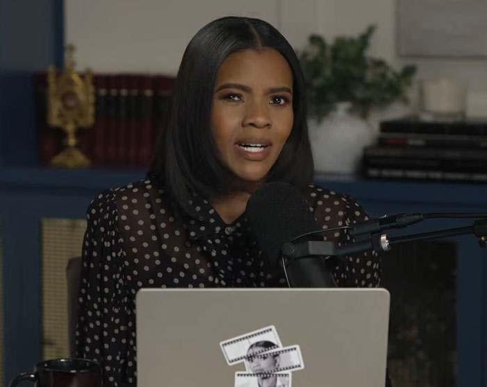 Erika Kirk speaking into a microphone during a podcast recording, her grin fueling backlash after Charlie’s passing.