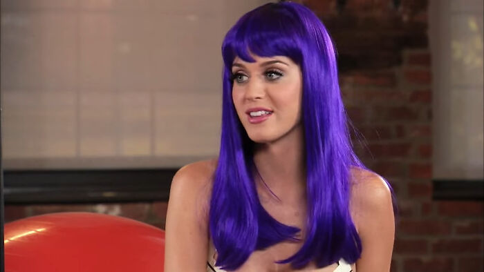 Celebrity with bright purple hair giving a savage response during an interview to an intrusive or annoying question.