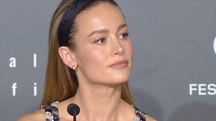 A female celebrity wearing a headband speaking at a press event with savage responses to annoying interview questions.