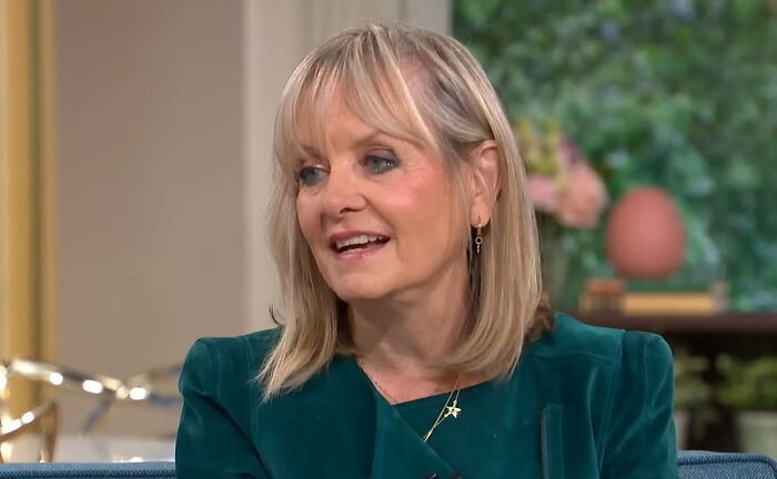 Woman with blonde hair wearing a teal blazer giving a savage response during an interview about annoying questions.