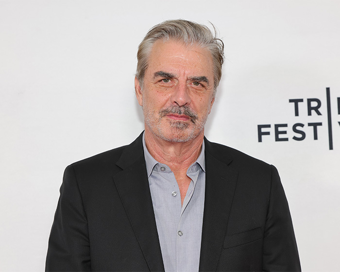 Chris Noth at a film festival event, wearing a black blazer and gray shirt, with a serious expression. Chris Noth at a film festival event, wearing a black blazer and gray shirt, with a serious expression.