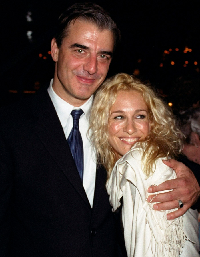 Chris Noth and Sarah Jessica Parker smiling and posing together at a nighttime event, showing past friendship moments.