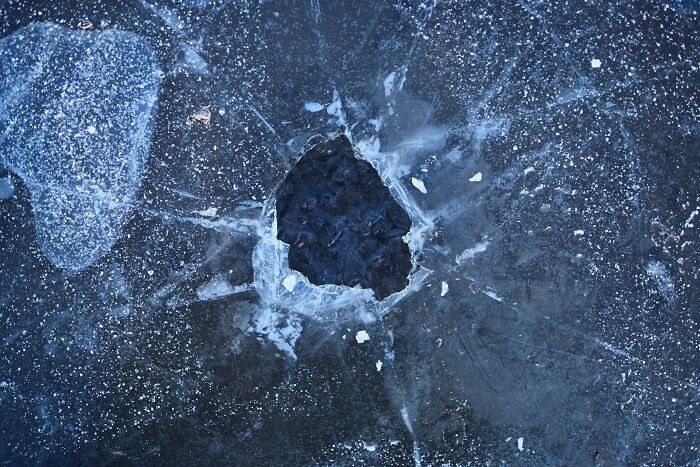 C*****d ice surface with a hole, symbolizing a common problem solved in shipping containers maintenance.