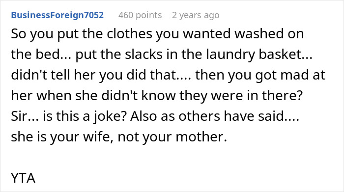 Screenshot of a Reddit comment criticizing a man blaming his wife for not having slacks for his business trip.