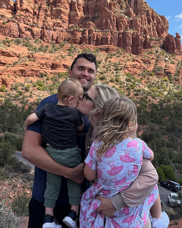 Erika Kirk with family outdoors near red rock cliffs, highlighting custody speculation and congresswoman controversy.