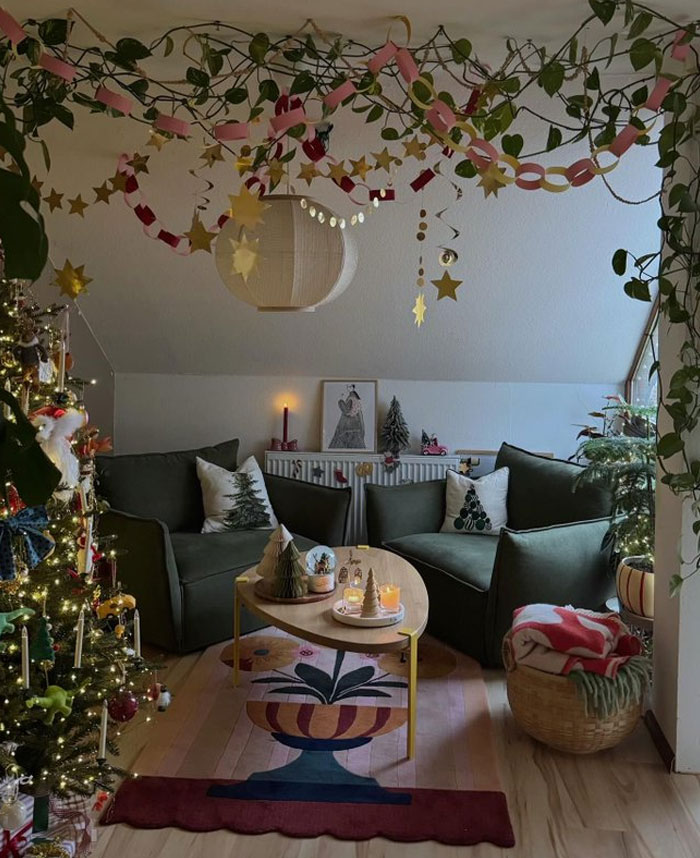 Cozy living room with festive decor, green sofas, and creative interior design ideas enhancing home aesthetics.