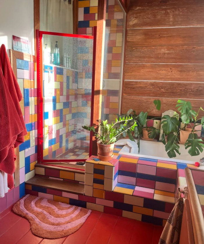 Bright bathroom interior featuring colorful tile design and lush green plants for cool interior design ideas.