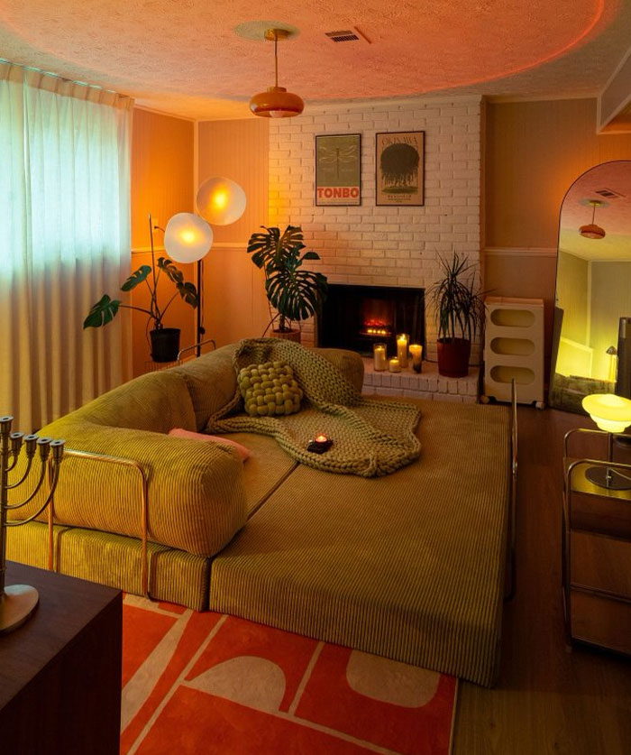 Cozy modern living room with warm lighting, green plants, and stylish interior design ideas for a trendy home atmosphere.