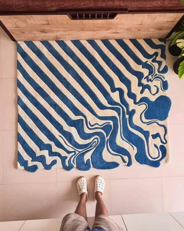 Abstract blue and white patterned rug showcasing cool interior design ideas in a contemporary home setting.