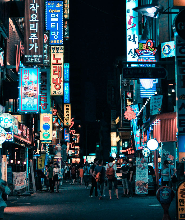 Tokyo neon street scene at night with crowds, colorful vertical signs and lit storefronts