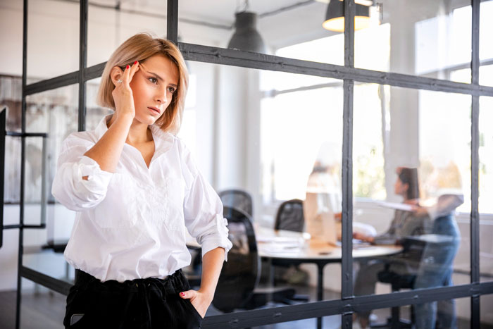 Married lady in white shirt looks shocked and confused at office after coworker claims they are hitched as second hubby.