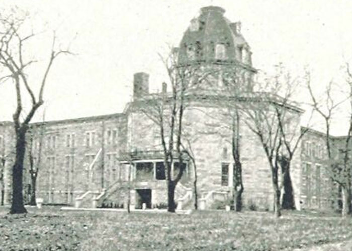 Old stone building surrounded by leafless trees, evoking unsettling history and crime stories that people find hard to believe.