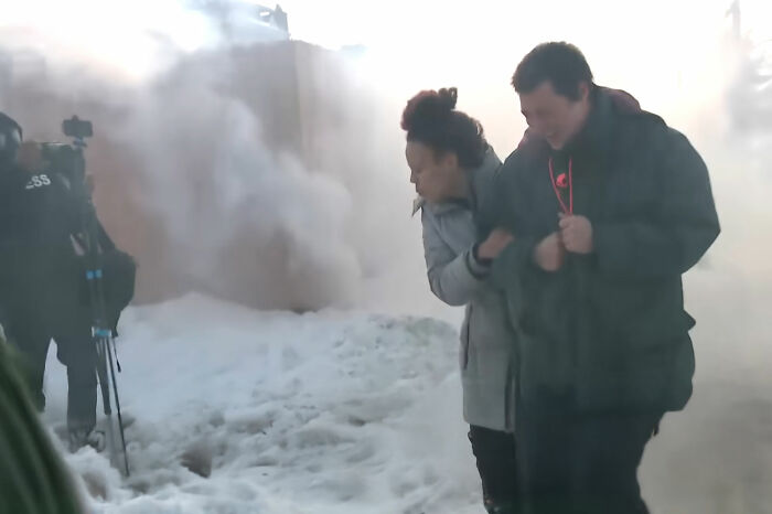 Family in distress outside building filled with smoke, highlighting tragic incident involving mom slain by ICE agent.