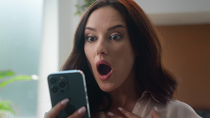 Woman shocked by text message on phone, reacting to dad&rsquo;s mistress revealing months-long affair on New Year's Eve.