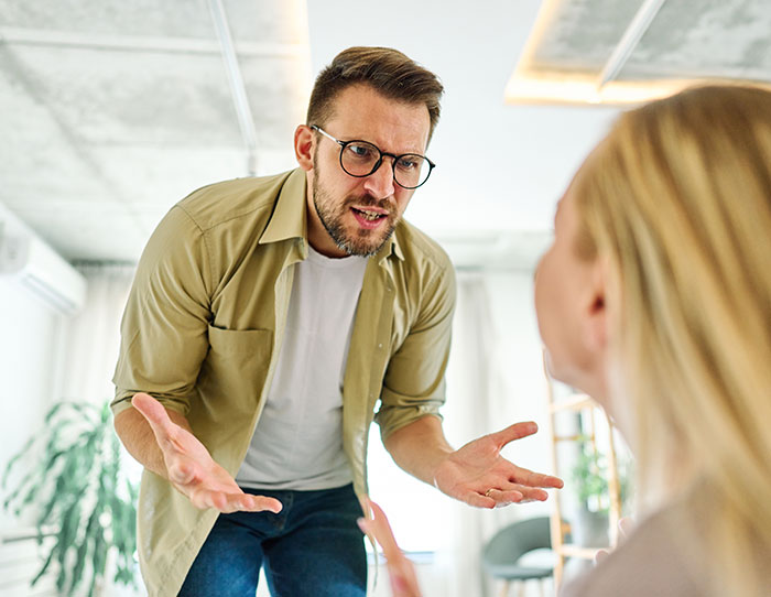 Angry husband telling wife not to use dangerous gift from her mom, wife ignoring his concerns during a heated discussion.