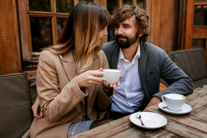 Couple on a second date at a coffee shop, highlighting recovering alcoholic avoiding bars during their outing.