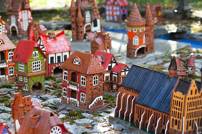 Detailed miniature cottages arranged outdoors, illustrating a daughter’s cottage building hobby sparking mom’s cheerleader wish. Detailed miniature cottages arranged outdoors, illustrating a daughter’s cottage building hobby sparking mom’s cheerleader wish.