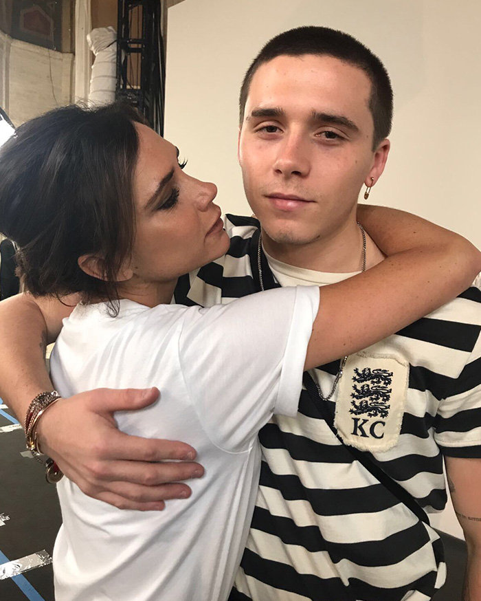 Woman hugging a young man wearing a striped shirt, illustrating family rift and public teasing amid worst crisis faced.