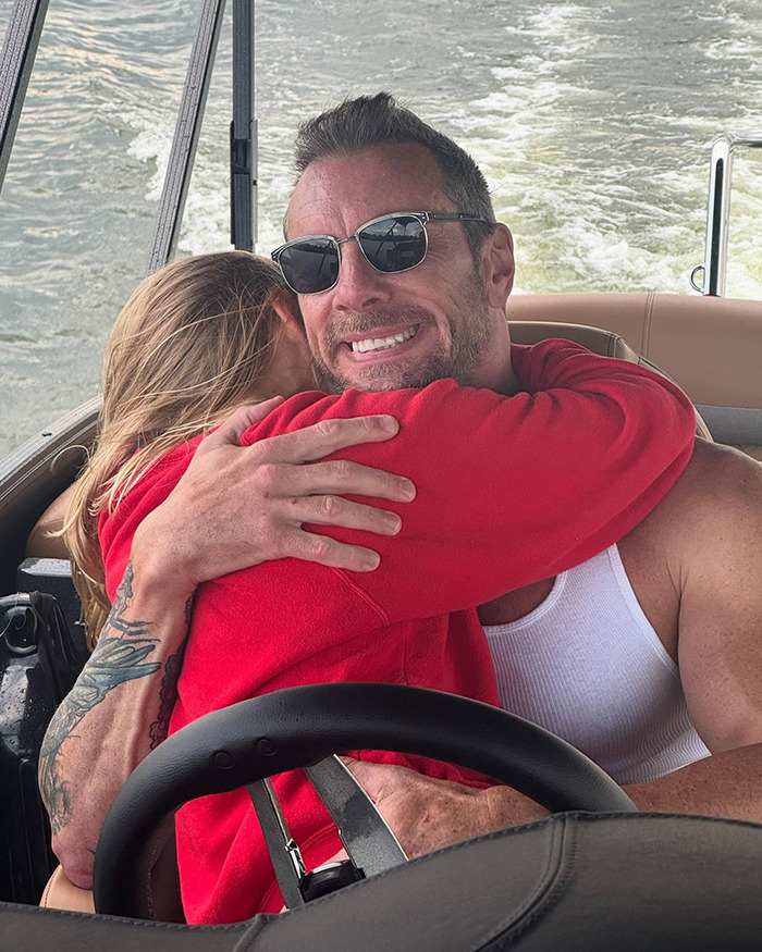 Dax Shepard smiling and hugging his daughter on a boat, capturing a heartfelt moment about freezing eggs discussed online.