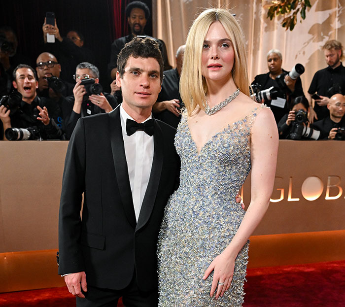 Elle Fanning towering in a shimmering gown at the Golden Globes, showcasing women are getting bigger in height and presence.