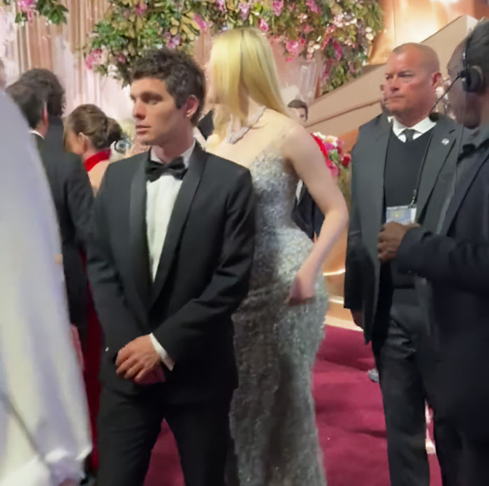 Elle Fanning towering over other stars at Golden Globes, highlighting women are getting bigger in height and presence.