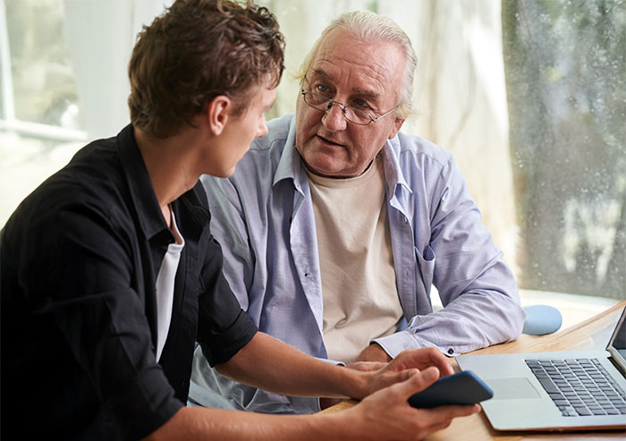Older man upset talking seriously with his 27-year-old son who refuses to let him track his car with an AirTag for safety.