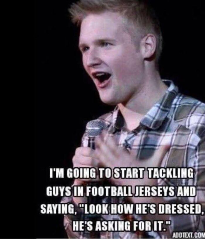 Young man in plaid shirt holding microphone with feminist post calling out patriarchy through a sarcastic statement.