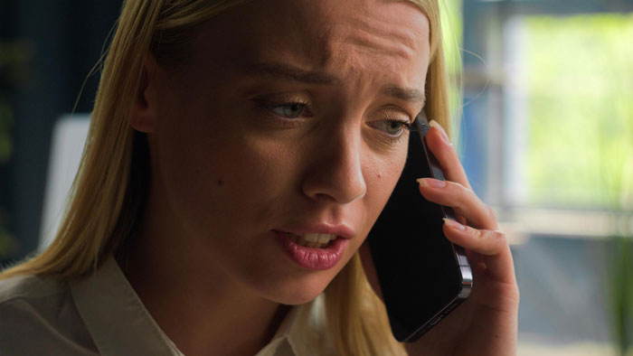 Woman looking worried while speaking on phone, reflecting tension over fiancé’s tattoo designed by ex and wedding postponement. Woman looking worried while speaking on phone, reflecting tension over fiancé’s tattoo designed by ex and wedding postponement.