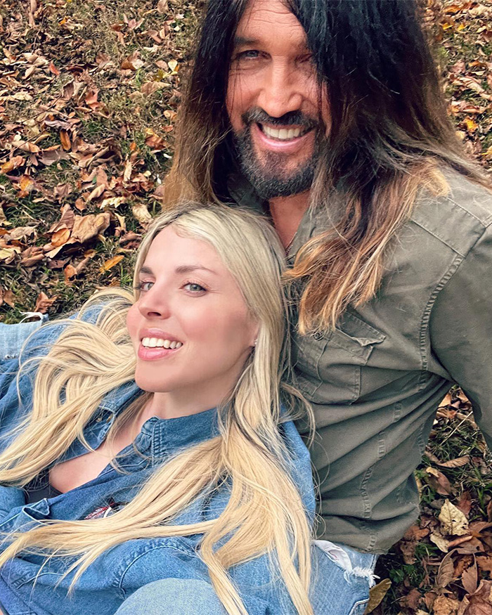 Firerose and Billy Ray Cyrus posing outdoors amidst autumn leaves, highlighting Firerose's bombshell audio accusations.