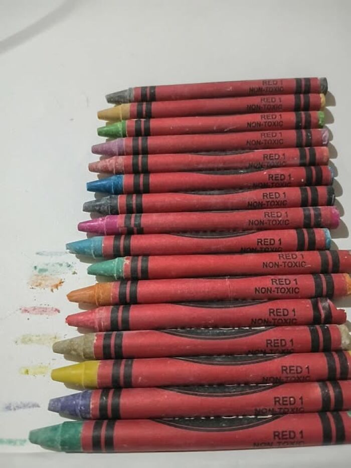 Woke up: row of red-wrapped crayons with assorted colored tips and smudges on white paper