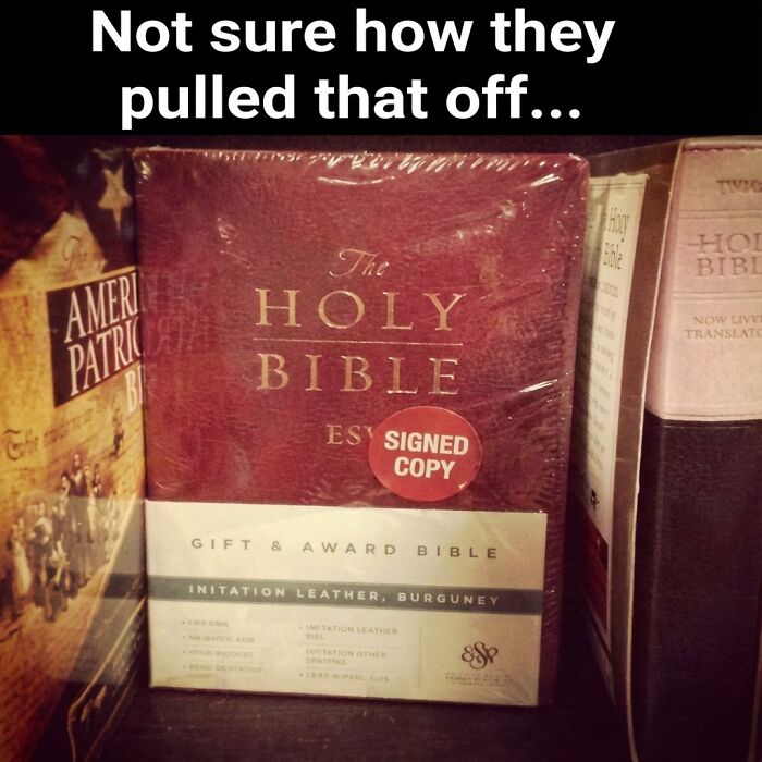 Red Holy Bible with a signed copy sticker on a bookshelf, part of funny memes that might crack you up with randomness.