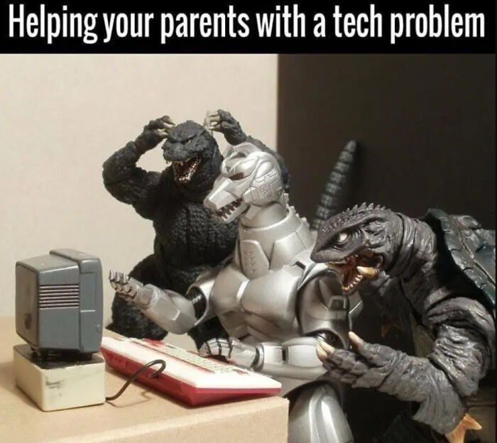 Three science fiction monster figures appear frustrated while helping with a tech problem on an old computer.