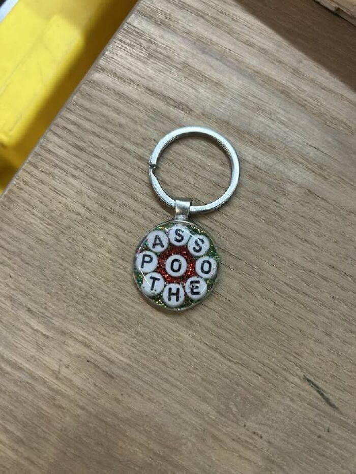 Keychain on a wooden surface with jumbled letters confusing the meaning, illustrating people breaking their brain trying to understand.