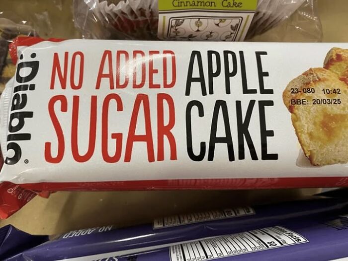 Packaged apple cake labeled no added sugar with a confusing label that challenges reading comprehension.