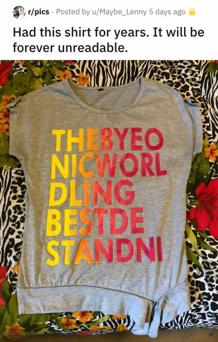 Gray shirt with colorful jumbled letters that confuse viewers and break their brain trying to understand the text.