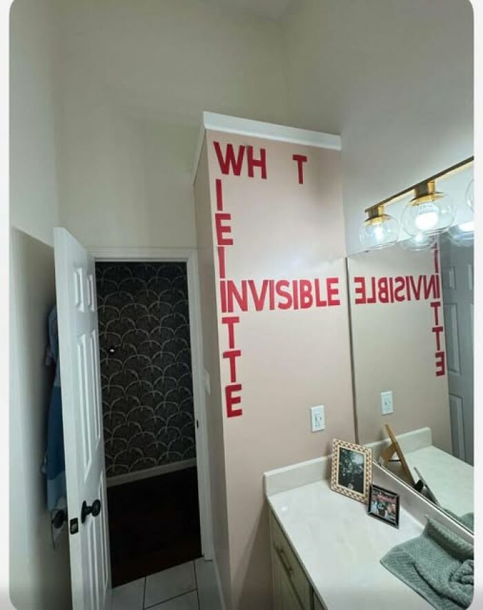 Wall text spelling invisible in bathroom, with letters arranged confusingly to break the brain while reading.