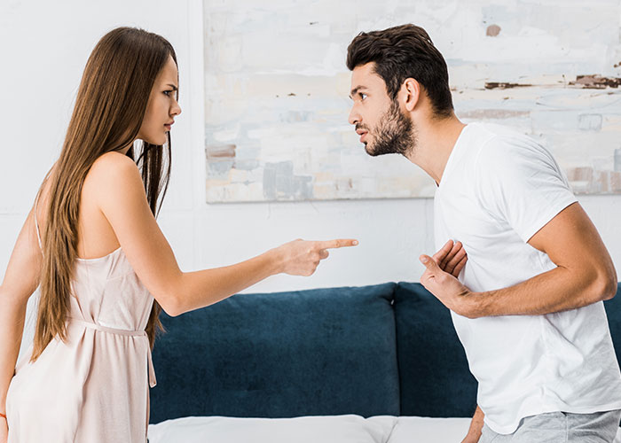 Woman and man arguing intensely in a living room, illustrating a dramatic moment in an award winning act court case.